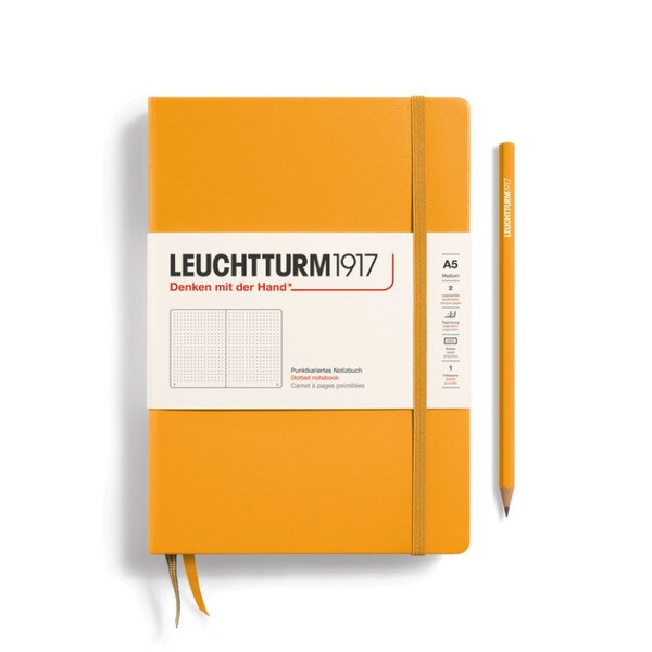 Rising sun yellow hardcover dotted notebook with closure strap and two bookmarks.